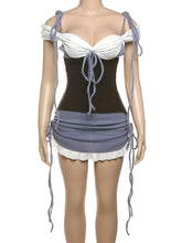 Mannequin wearing a black and white dress with blue accents on a white background